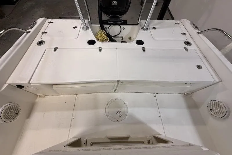 Slide: The Image of 2011 Boston Whaler 230 Dauntless boat interior, featuring storage compartments and seating area. - 6