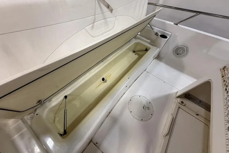 Slide: The Image of 2011 Boston Whaler 230 Dauntless boat interior storage compartment, open and empty. - 8