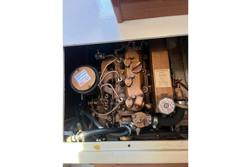 Slide: The Image of Engine compartment of a 1988 Catalina 30 sailboat, featuring a Universal diesel engine. - 11