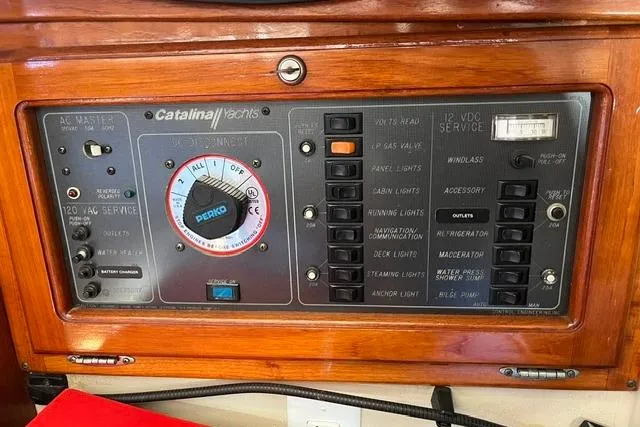 Slide: The Image of Control panel of a 1988 Catalina 30 yacht with various switches and dials. - 13