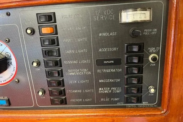 Slide: The Image of 1988 Catalina 30 control panel with switches for lights, windlass, and bilge pump. - 15
