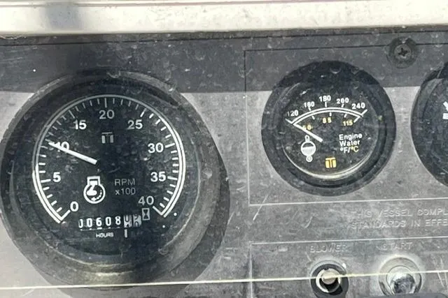 Slide: The Image of Dashboard gauges of a 1988 Catalina 30 boat, showing RPM and engine water temperature. - 16
