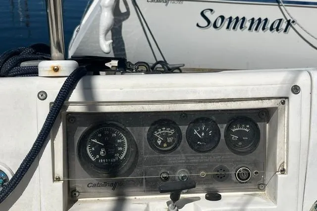 Slide: The Image of Control panel of a 1988 Catalina 30 sailboat with gauges and nautical ropes. - 17