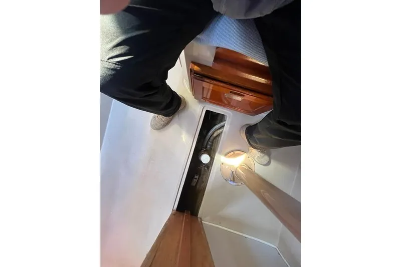Slide: The Image of Interior view of a 1988 Catalina 30 sailboat, showing a cabin area with a wooden cabinet. - 18