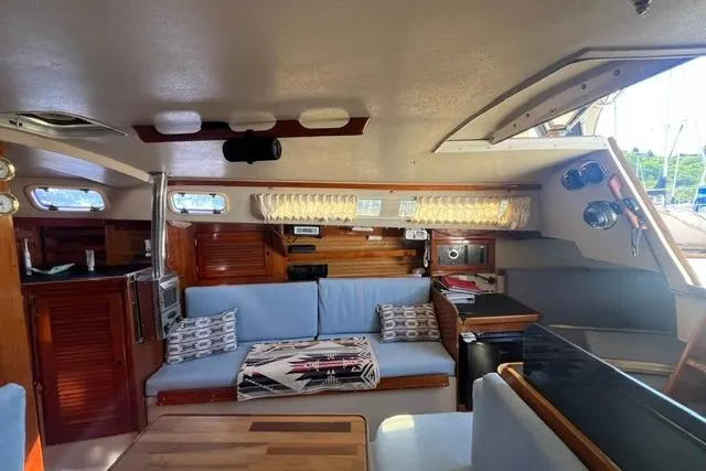 Slide: The Image of Interior of a 1988 Catalina 30 sailboat with cozy seating and wooden accents. - 19