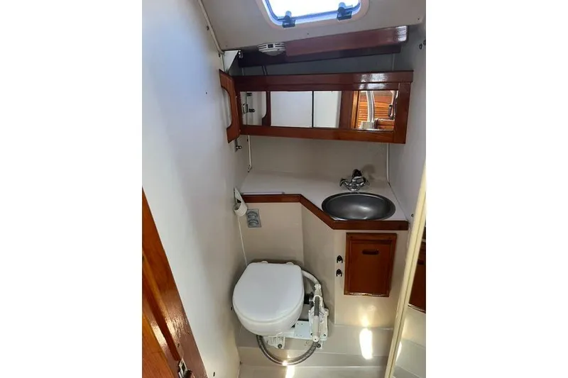Slide: The Image of Bathroom interior of a 1988 Catalina 30 sailboat with sink and toilet. - 23