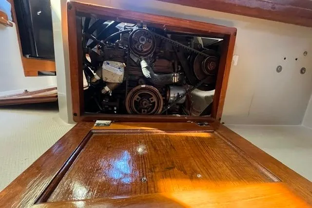 Slide: The Image of Engine compartment of a 1988 Catalina 30 sailboat, showcasing mechanical components. - 7