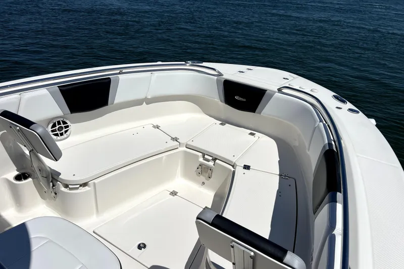 Slide: The Image of 2021 Robalo R272 Center Console boat interior with seating, on calm water. - 11