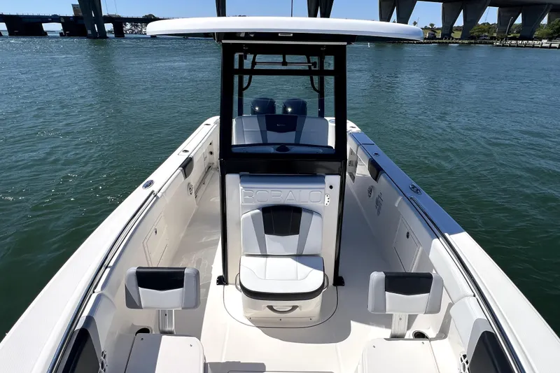 Slide: The Image of 2021 Robalo R272 Center Console boat on water, showcasing sleek design and spacious seating. - 13