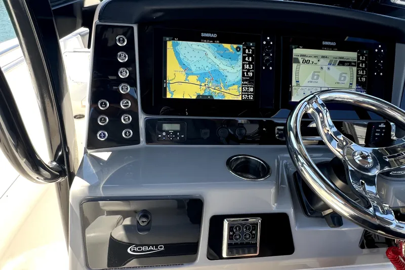 Slide: The Image of 2021 Robalo R272 Center Console dashboard with navigation screens and controls. - 18