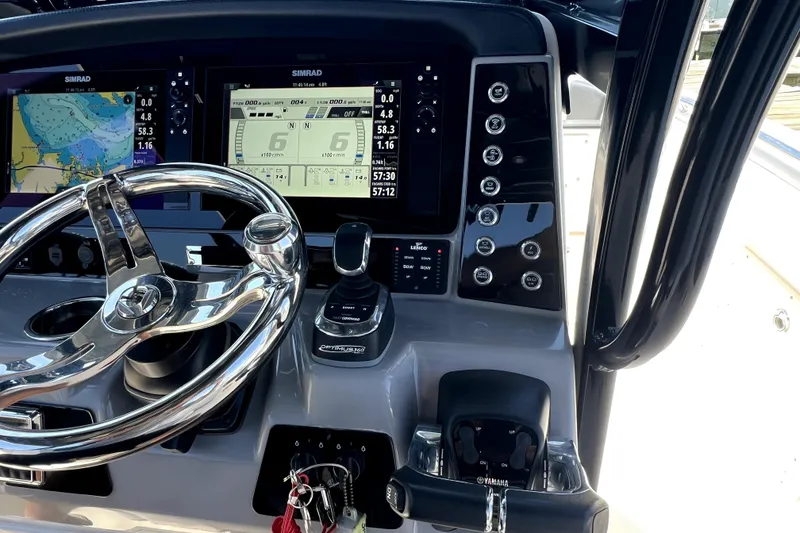 Slide: The Image of 2021 Robalo R272 Center Console dashboard with Simrad displays and steering wheel. - 19