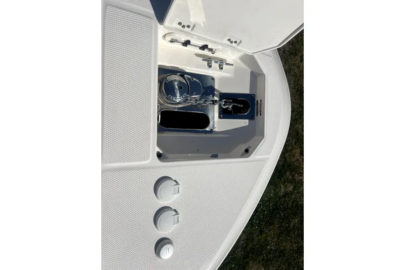 Slide: The Image of 2021 Robalo R272 Center Console anchor compartment with open hatch and visible fittings. - 23