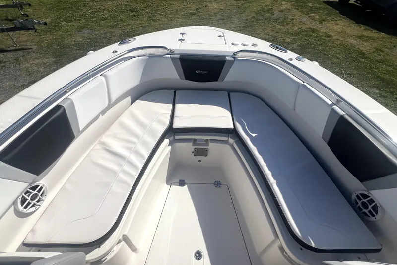Slide: The Image of 2021 Robalo R272 Center Console boat interior with cushioned seating and storage compartments. - 24