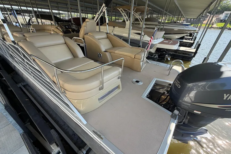 Slide: The Image of 2011 Bennington 2575QCW OB pontoon boat with Yamaha outboard motor, docked in marina. - 10