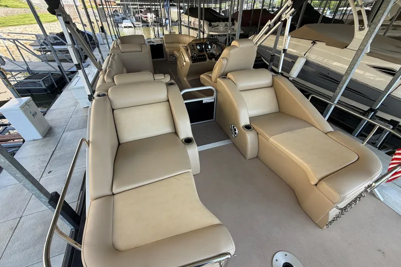 Slide: The Image of Luxurious interior of a 2011 Bennington 2575QCW OB pontoon boat with beige seating. - 11
