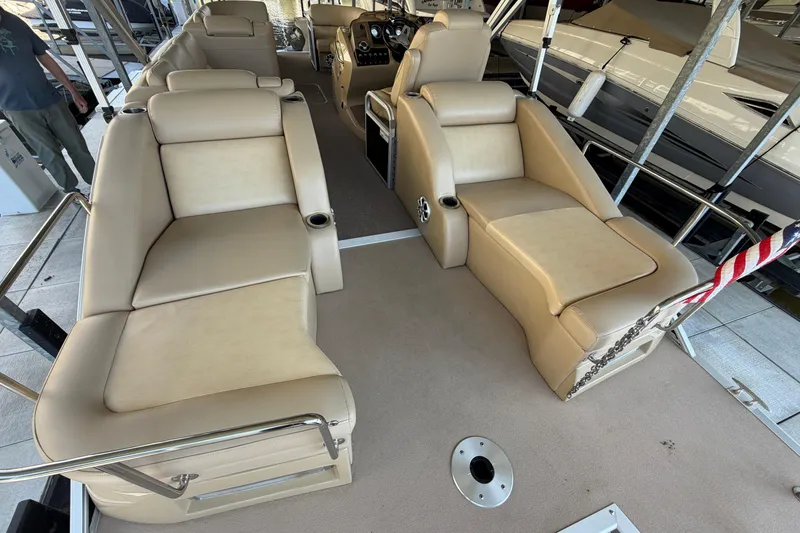 Slide: The Image of Luxurious interior of a 2011 Bennington 2575QCW OB pontoon boat with beige seating. - 12