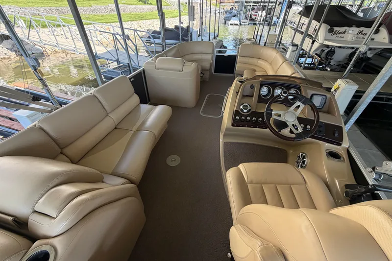 Slide: The Image of Luxurious interior of a 2011 Bennington 2575QCW OB pontoon boat with beige seating. - 14