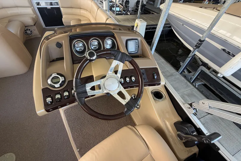 Slide: The Image of Steering console of a 2011 Bennington 2575QCW OB pontoon boat with gauges and controls. - 17