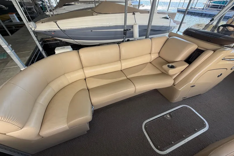 Slide: The Image of Luxurious seating on a 2011 Bennington 2575QCW OB pontoon boat, featuring beige upholstery. - 20