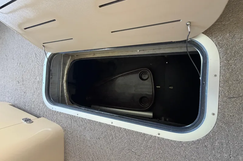 Slide: The Image of Open storage compartment on a 2011 Bennington 2575QCW OB boat. - 21