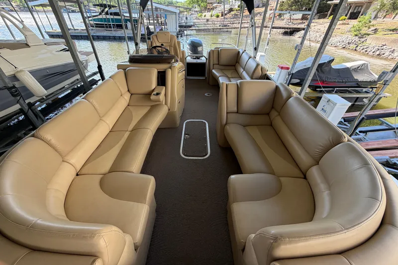 Slide: The Image of Luxurious interior of a 2011 Bennington 2575QCW OB pontoon boat with tan seating. - 24