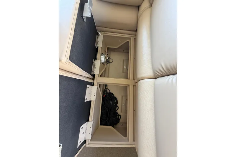 Slide: The Image of Open storage compartments in a 2011 Bennington 2575QCW OB boat, showcasing interior space. - 25