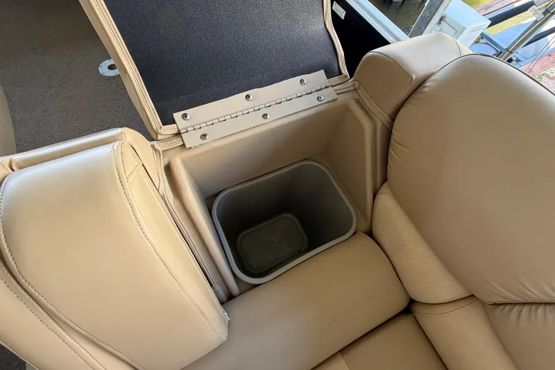 Slide: The Image of 2011 Bennington 2575QCW OB boat seat with built-in storage compartment and beige upholstery. - 26
