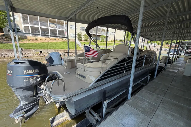 Slide: The Image of 2011 Bennington 2575QCW OB pontoon boat docked with Yamaha outboard motor. - 3
