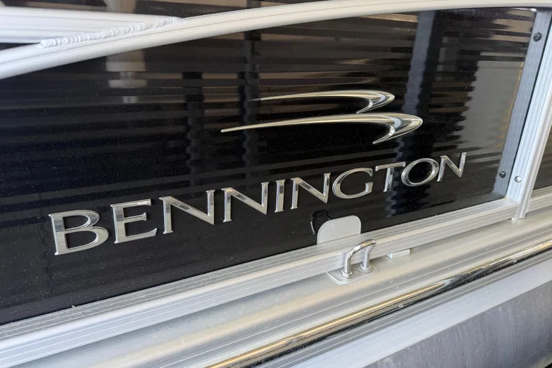Slide: The Image of Close-up of 2011 Bennington 2575QCW OB boat logo on black surface. - 8