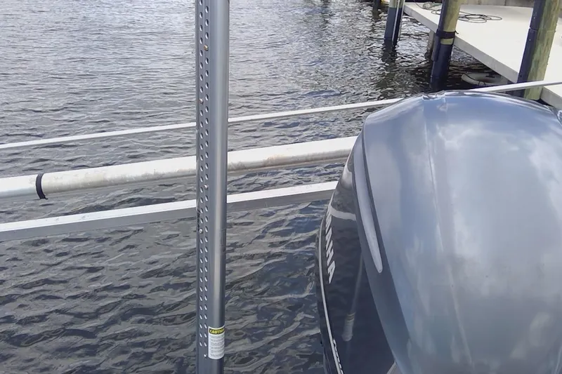 Slide: The Image of 2020 Key West 263 FS boat with beige seating, docked on water. - 13