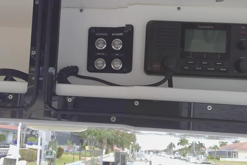 Slide: The Image of 2020 Key West 263 FS boat interior with beige seating and deck features. - 14