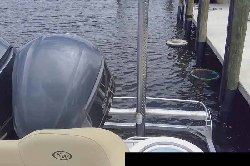 Slide: The Image of 2020 Key West 263 FS boat docked near waterfront homes, featuring Yamaha engine. - 17
