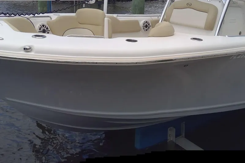 Slide: The Image of 2020 Key West 263 FS boat interior with beige seating and cup holders. - 19