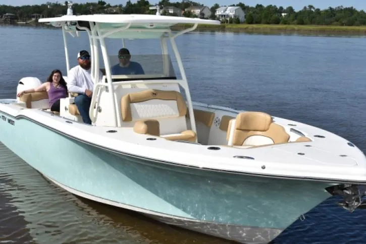 Slide: The Image of 2020 Key West 263 FS boat interior with cushioned seating and storage compartment. - 2