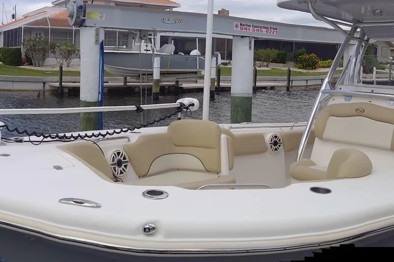 Slide: The Image of 2020 Key West 263 FS boat with beige seating at a marina dock. - 20
