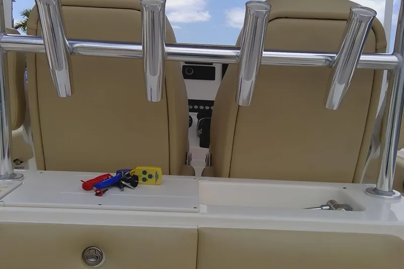 Slide: The Image of 2020 Key West 263 FS boat interior with rod holders and keys on console. - 21