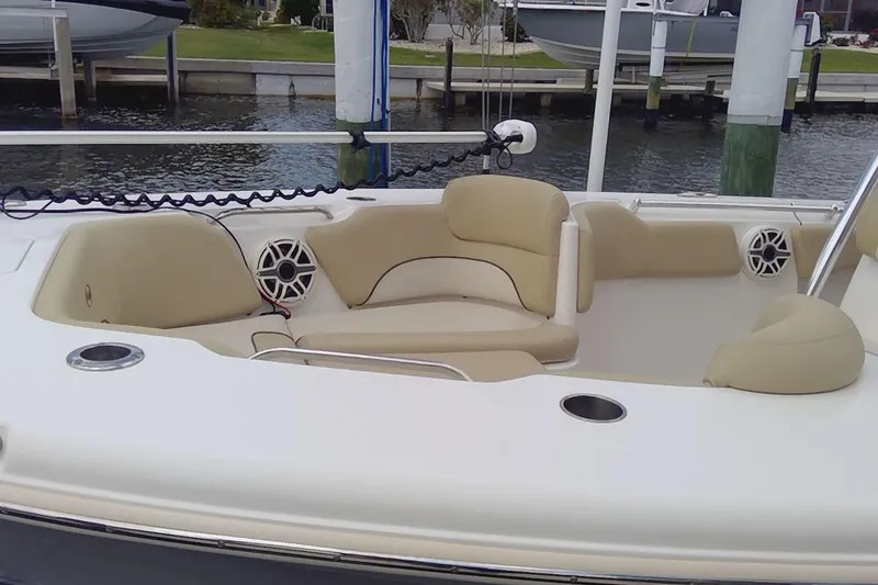 Slide: The Image of 2020 Key West 263 FS boat with Yamaha engines, featuring beige seating and a clean deck. - 26