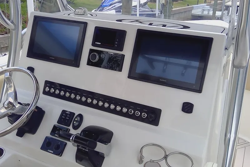 Slide: The Image of 2020 Key West 263 FS boat interior with steering console and seating. - 29