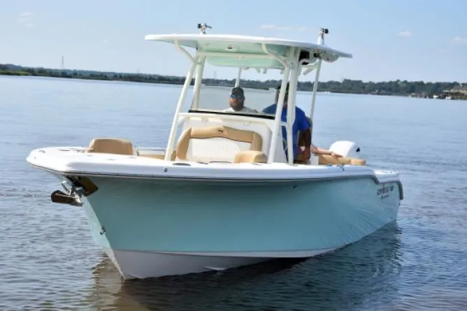 Slide: The Image of Storage area in a 2020 Key West 263 FS boat with speaker and Bass Pro Shops bag. - 3