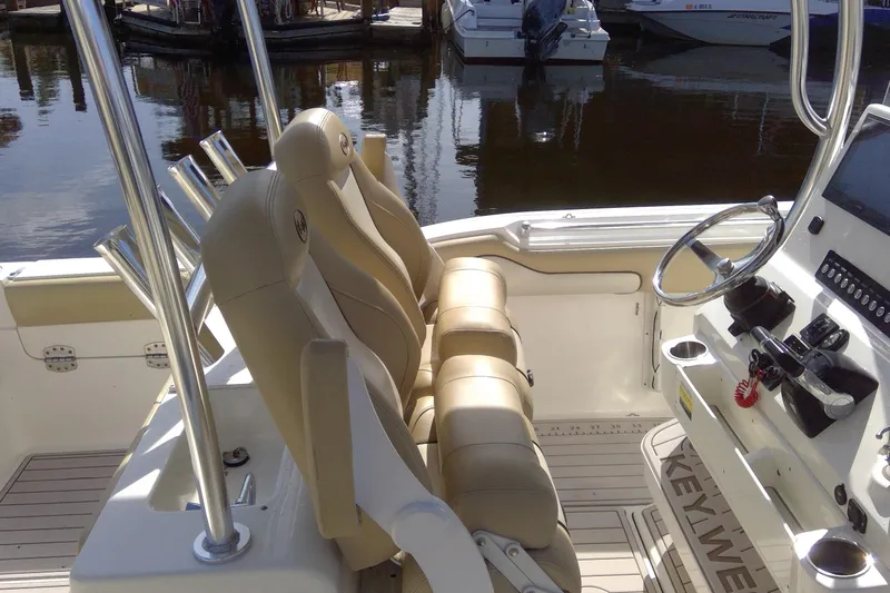 Slide: The Image of 2020 Key West 263 FS boat interior with beige seating and steering console. - 34