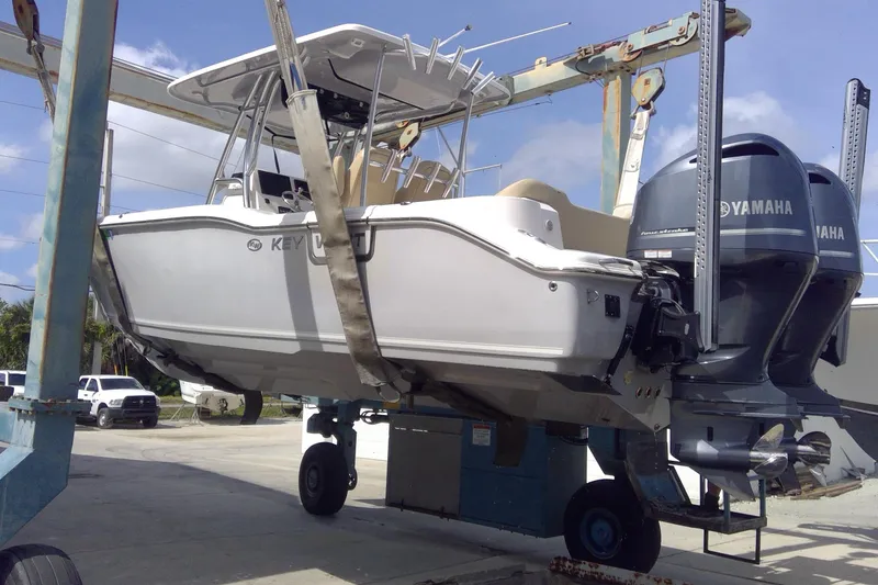 Slide: The Image of 2020 Key West 263 FS boat with Yamaha engines on a lift at a marina. - 36