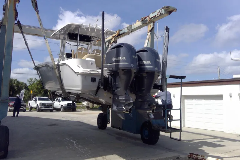 Slide: The Image of 2020 Key West 263 FS boat with dual Yamaha engines being lifted by a crane. - 37