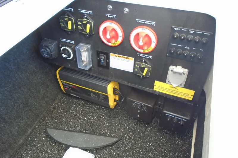 Slide: The Image of Control panel of a 2022 Regal LX6 boat with switches and battery indicators. - 10