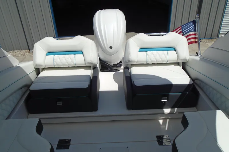 Slide: The Image of 2022 Regal LX6 boat interior with white seating and American flag. - 12