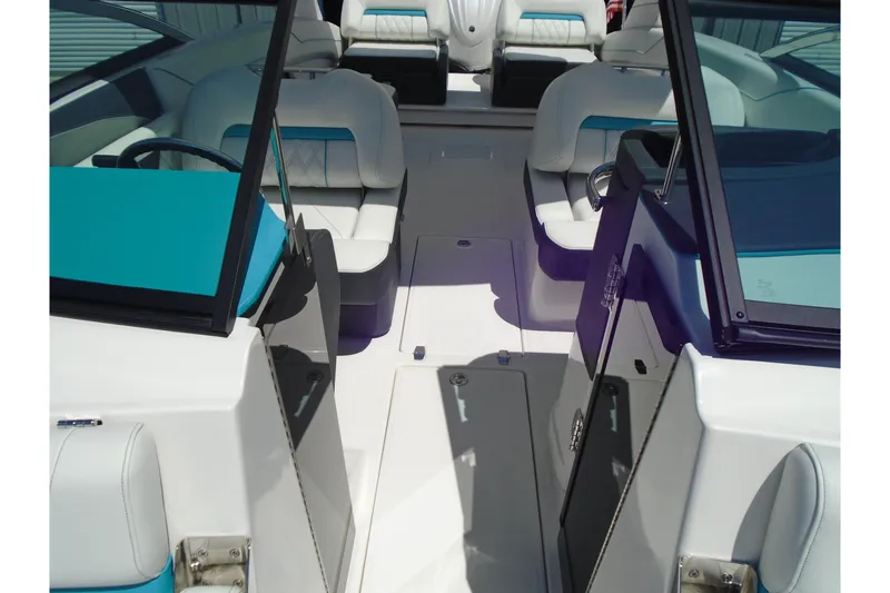 Slide: The Image of 2022 Regal LX6 boat interior with white and teal seating, showcasing modern design. - 15
