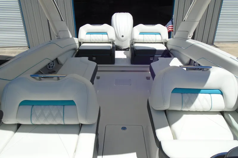 Slide: The Image of Luxurious interior of 2022 Regal LX6 boat with white seating and blue accents. - 17