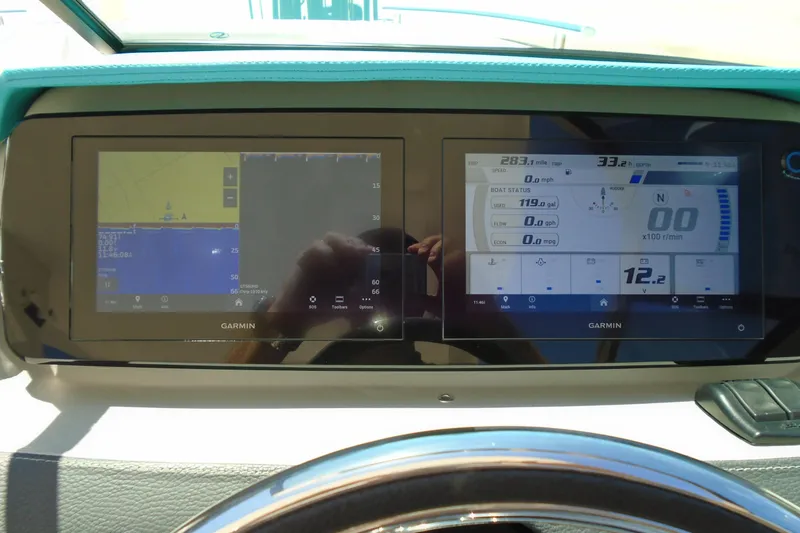 Slide: The Image of Dashboard of a 2022 Regal LX6 boat featuring dual Garmin navigation displays. - 20