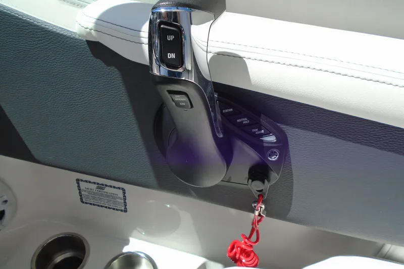 Slide: The Image of 2022 Regal LX6 boat throttle control with trim assist and safety lanyard. - 21