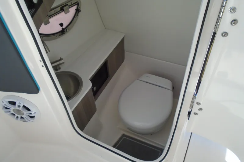 Slide: The Image of 2022 Regal LX6 boat bathroom with sink, toilet, and storage. - 22