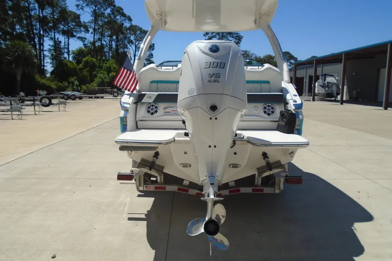 Slide: The Image of 2022 Regal LX6 boat with Yamaha 300 V6 engine, parked outdoors. - 3